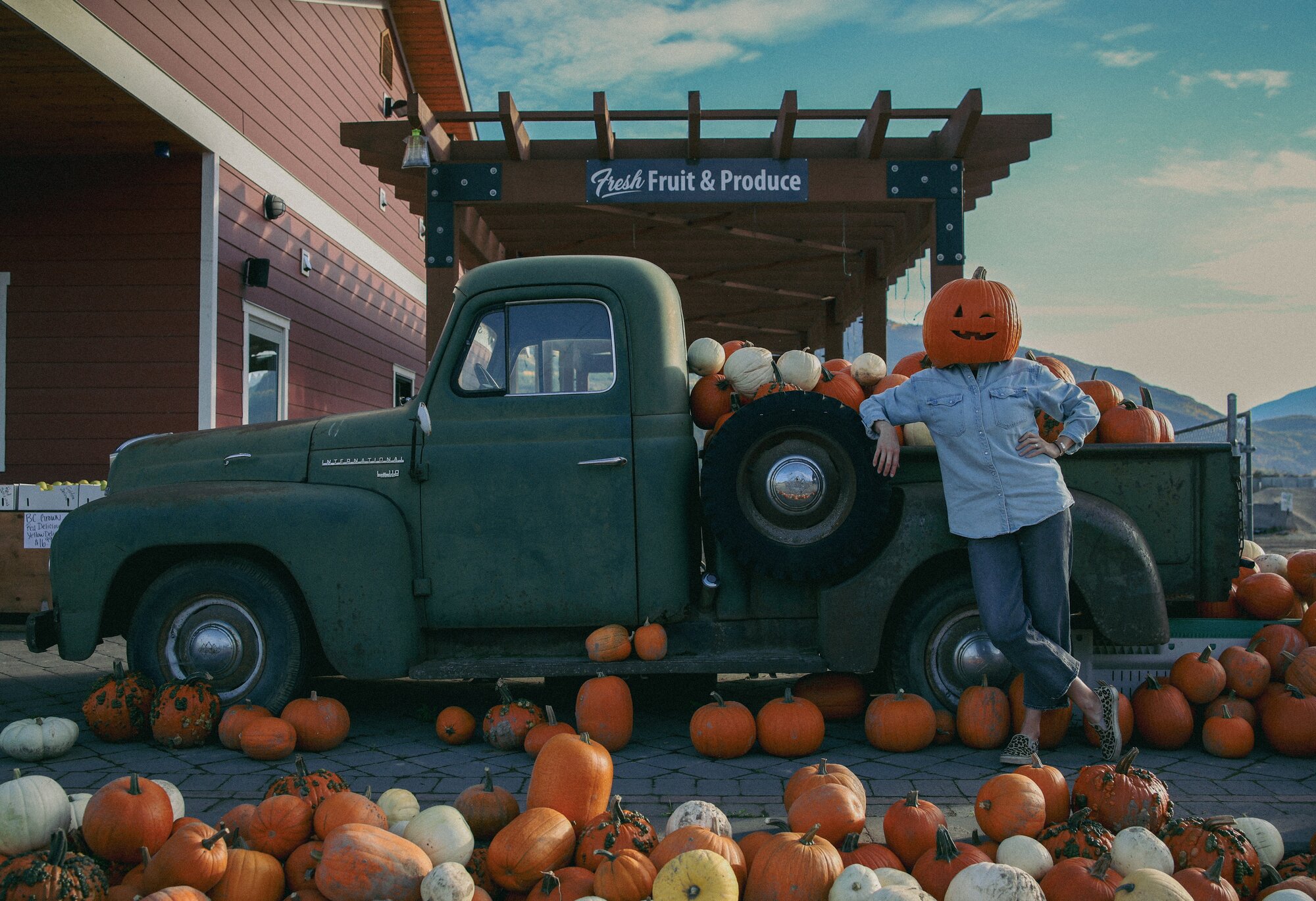 A vintage truck framed by pumpkins at a fall harvest farm stand near Salmon Arm