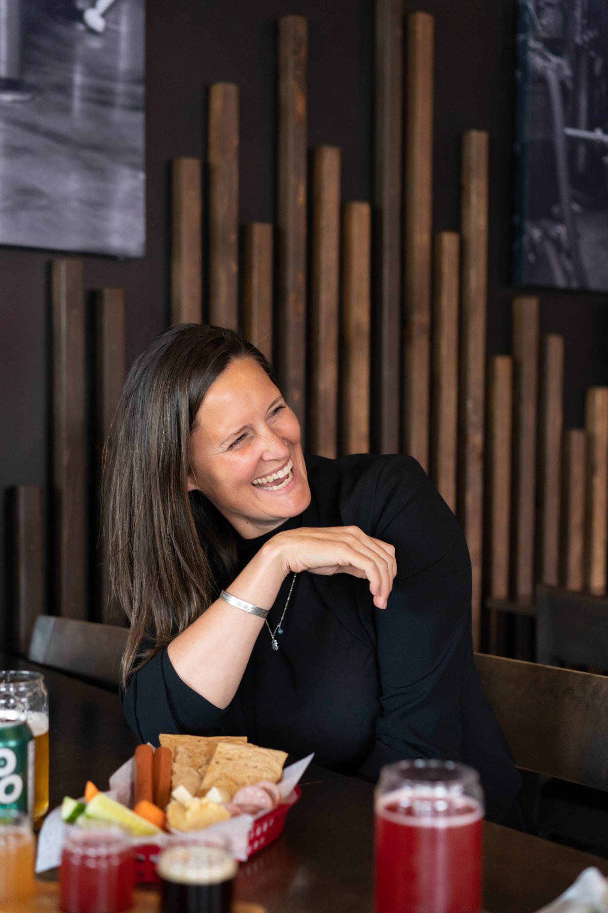 A visitor laughing over a flight of local beers on the Southern Interior Ale Trail