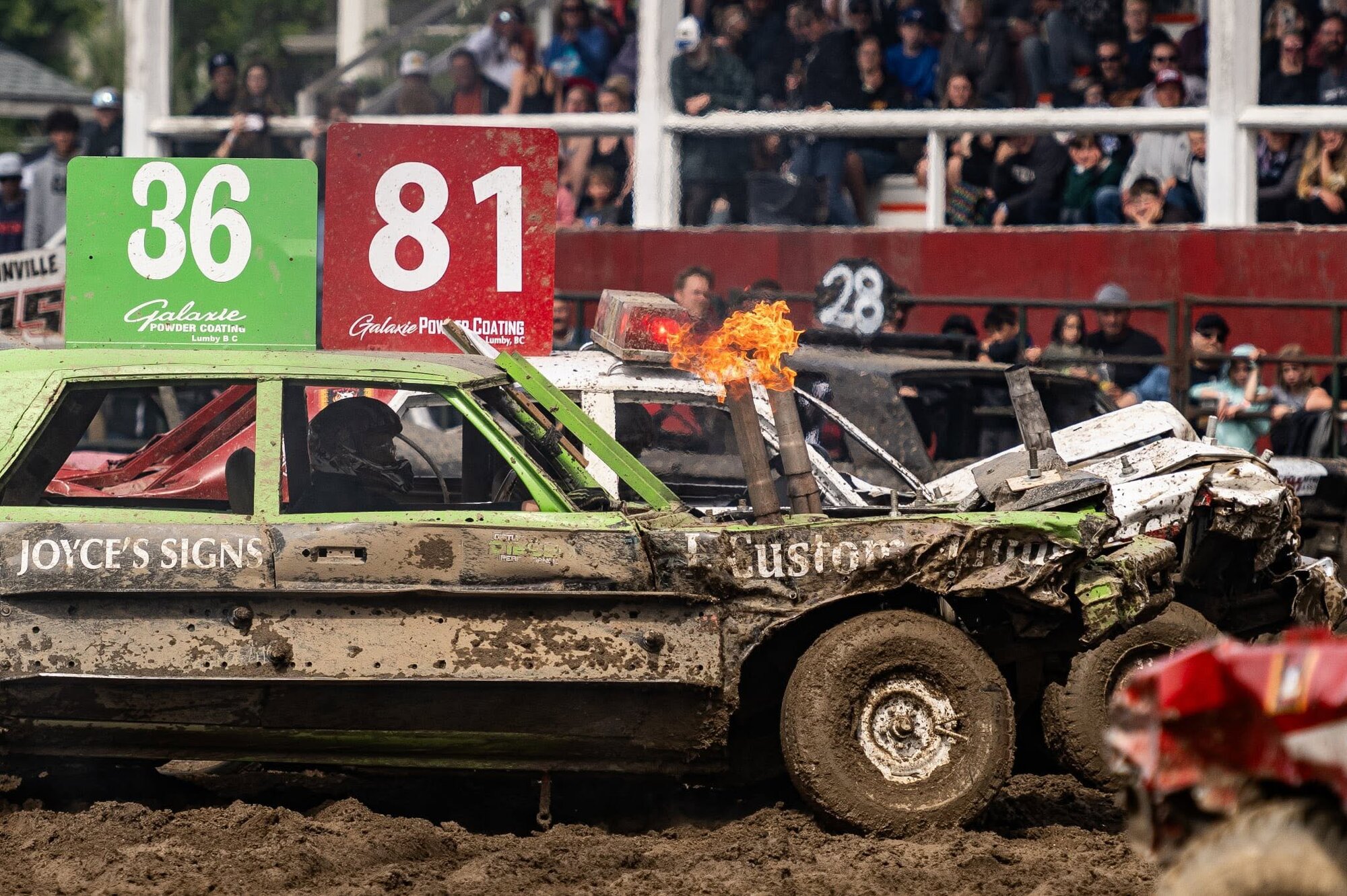 Demolition derby cars colliding in the arena at the Salmon Arm Fairgrounds