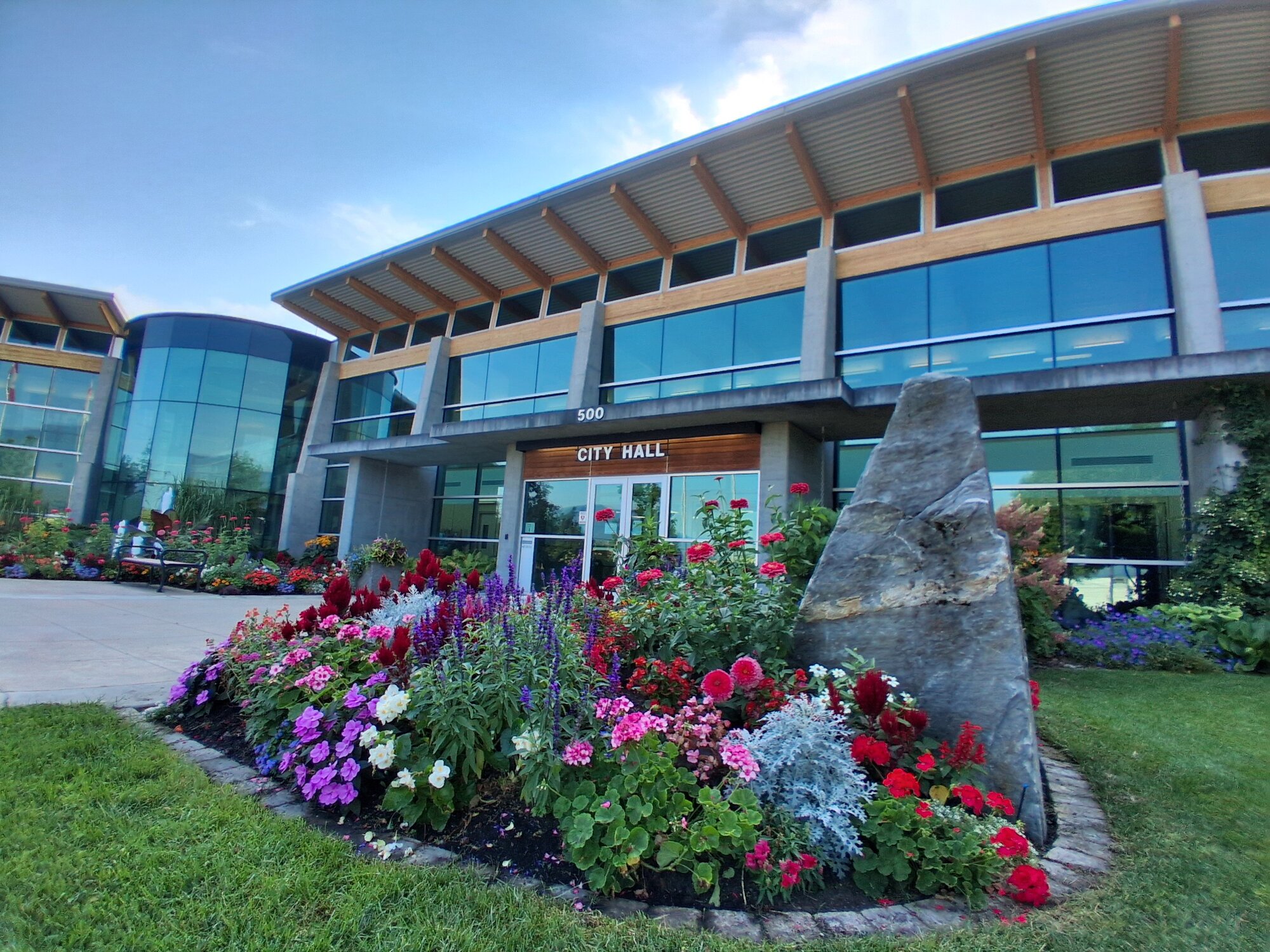 Salmon Arm City Hall — home of the Visitor Centre — behind a colourful summer flower bed